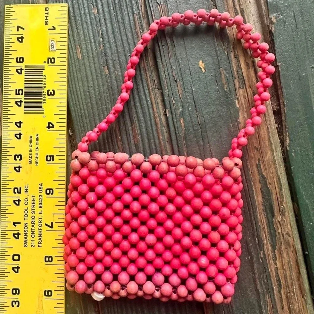 Pink and red beaded‎ bag with heart charm